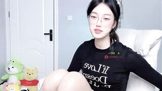 Caroline - Cute young Asian girl sweetly chatting and teasing with her clothes on in front of the camera